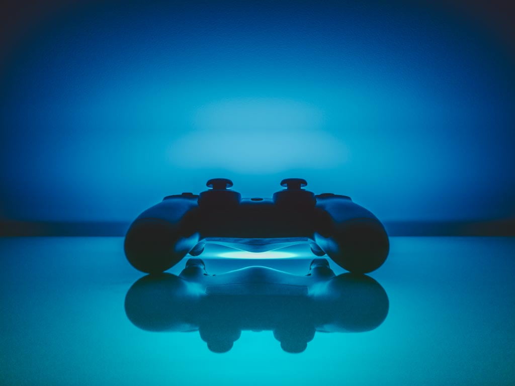 A games console controller on a shiny surface